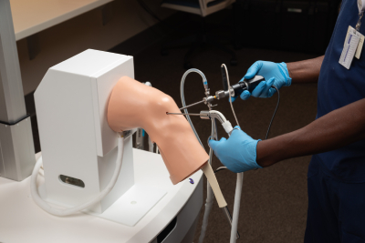 Student performs simulated knee surgery.